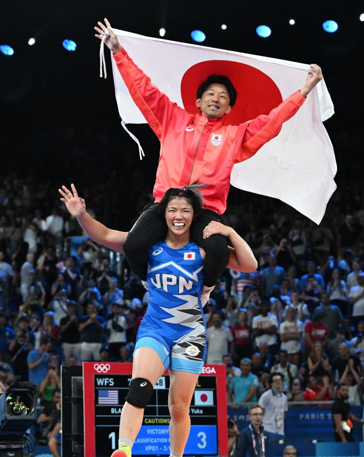 日本选手镜优翔（下）与教练庆祝夺冠